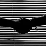 monochrome photography of people shaking hands