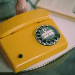 yellow and silver rotary phone