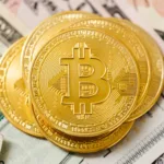 stacks of gold coins on paper money bill in close up photography