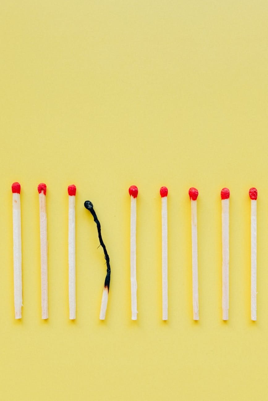 white and red candles on white surface