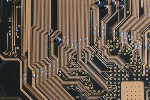 Detailed view of a circuit board with intricate gold traces.