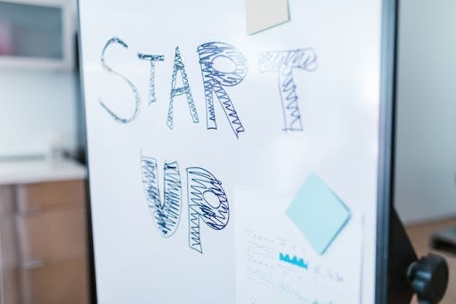 Creative startup concept handwritten on a whiteboard, symbolizing innovation in business.