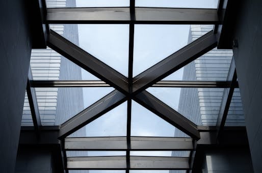 Industrial-style skylight with steel beams and glass panels in modern architecture.